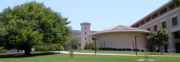 Expansive O'Neill Green with sidewalk leading past the Orfalea College of Business rotunda and campus Clock Tower. Photo by Walt Bremer, Professor, Landscape Architecture.